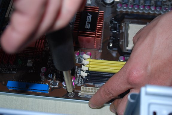 screwing motherboard